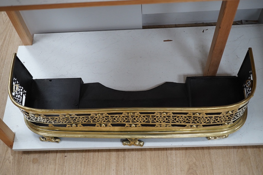 An early 19th century brass fender with pierced decoration, 91cm wide. Condition - fair to good